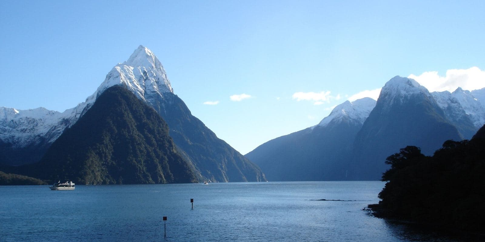Snow-capped peaks rising from the water at Milford Sound