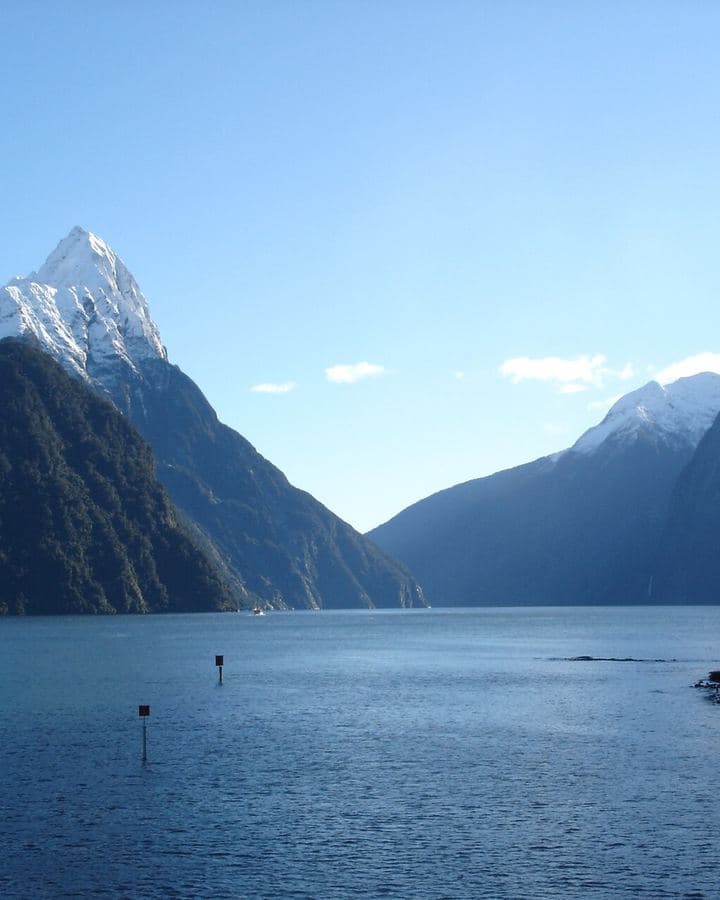 Snow-capped peaks rising from the water at Milford Sound