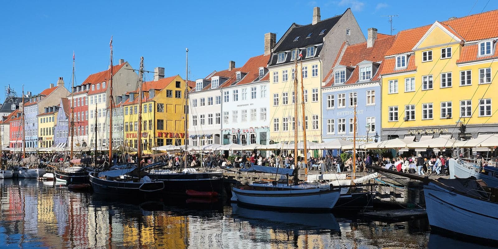 Colourful houses and boats along Nyhavn in Copenhagen